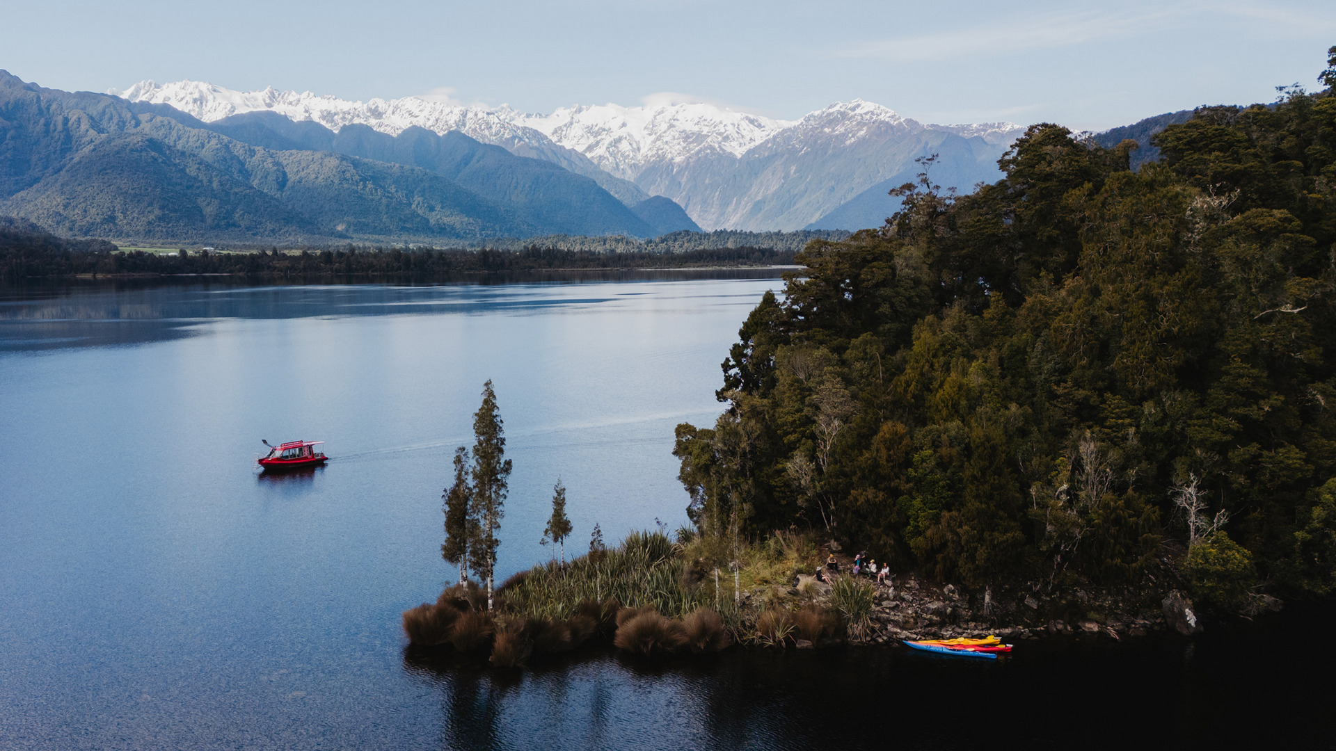 Immerse yourself in the untouched beauty of Lake Mapourika, part of the Te Wāhipounamu UNESCO World Heritage Area